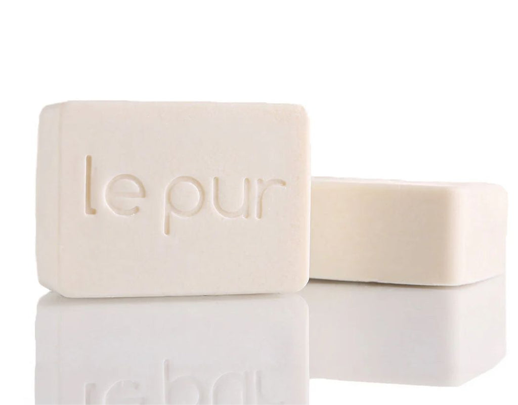 Le Pur Organics Blanch Beauty organic skincare product in a sleek bottle with natural ingredients visible.