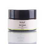 Le Pur Organics eye cream in a sleek jar, featuring natural ingredients for brightening and reducing puffiness around the eyes.