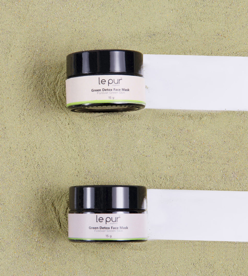 Green Detox Face Mask by Le Pur Organics, showing a vibrant green mask in a small jar with fresh ingredients around it.