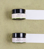 Green Detox Face Mask by Le Pur Organics, showing a vibrant green mask in a small jar with fresh ingredients around it.