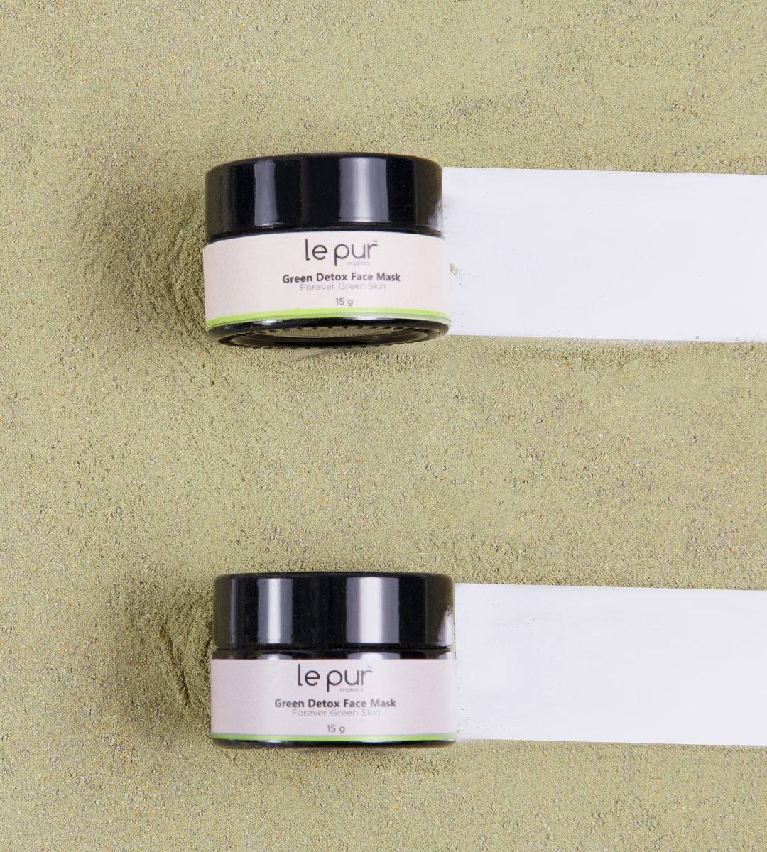 Green Detox Face Mask by Le Pur Organics, showing a vibrant green mask in a small jar with fresh ingredients around it.