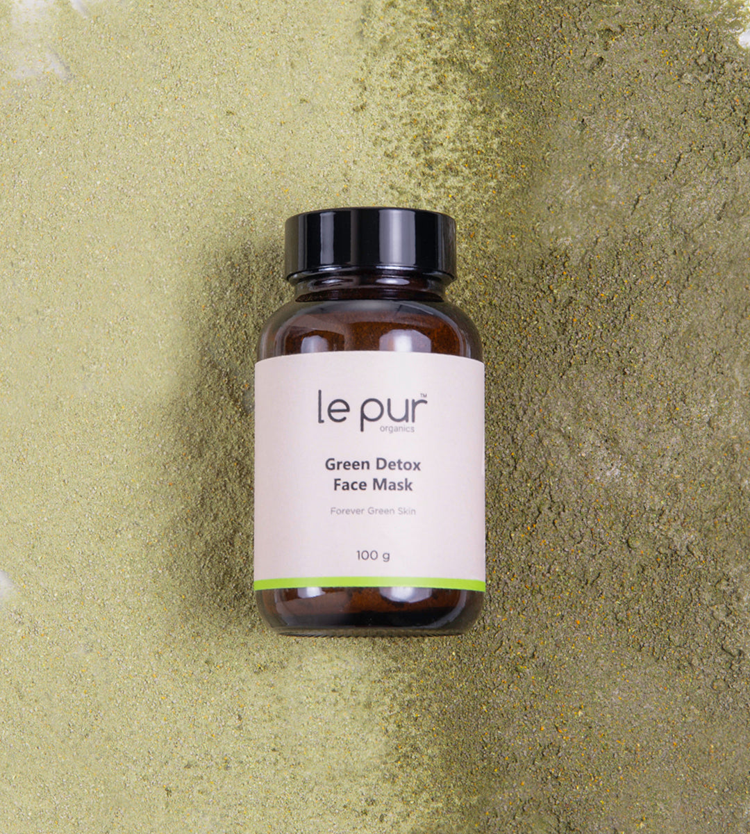 Green Detox Face Mask by Le Pur Organics, showing a vibrant green clay mask in a clear jar with fresh herbs and natural ingredients.