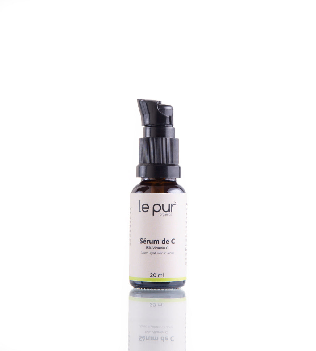 Le Pur Organics Sérum De C in a glass bottle with dropper, featuring bright orange liquid, for radiant skin and vitamin C boost.