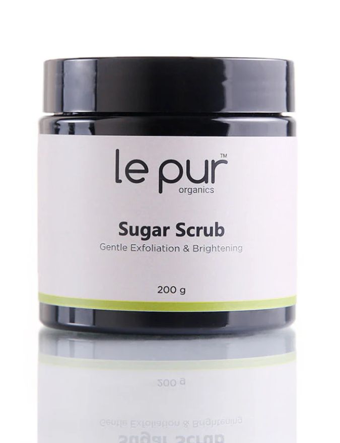 Le Pur Organics sugar scrub jar with textured sugar crystals and natural skincare ingredients, showcasing organic exfoliation.