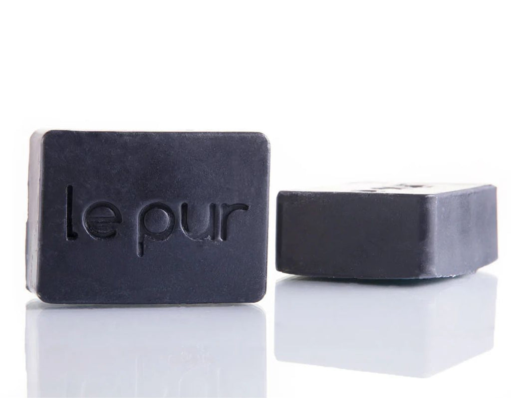 Black Beauty charcoal soap bar lathered in hands showing rich foam for a deep clean without a heavy feel - by Le Pur