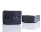 Black Beauty charcoal soap bar lathered in hands showing rich foam for a deep clean without a heavy feel - by Le Pur